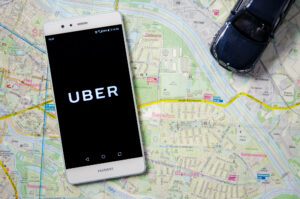 iphone on a map with the uber logo on display-Uber and Lyft Sexual Assault Lawyer 